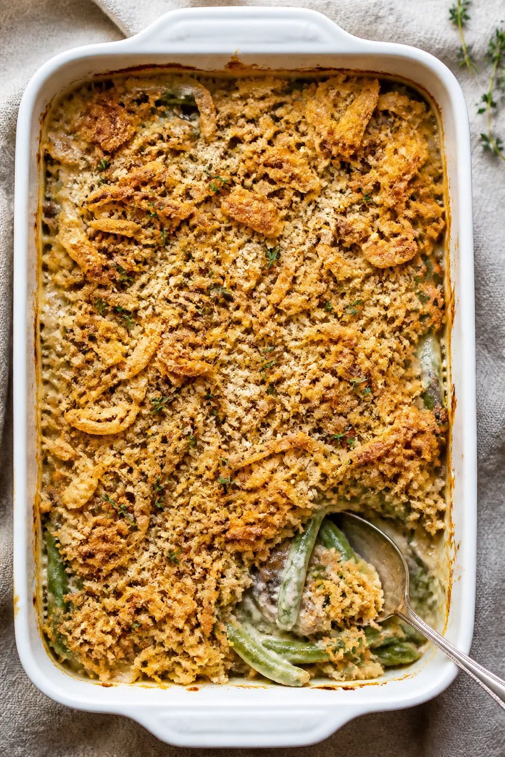 Final dish overhead: Make-ahead green bean casserole just baked in a 9x13 white ceramic dish, top vi