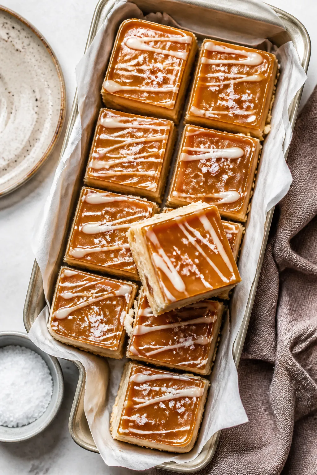 Final dish, tasty top view: Overhead shot of salted caramel white chocolate bars set with crushed sh