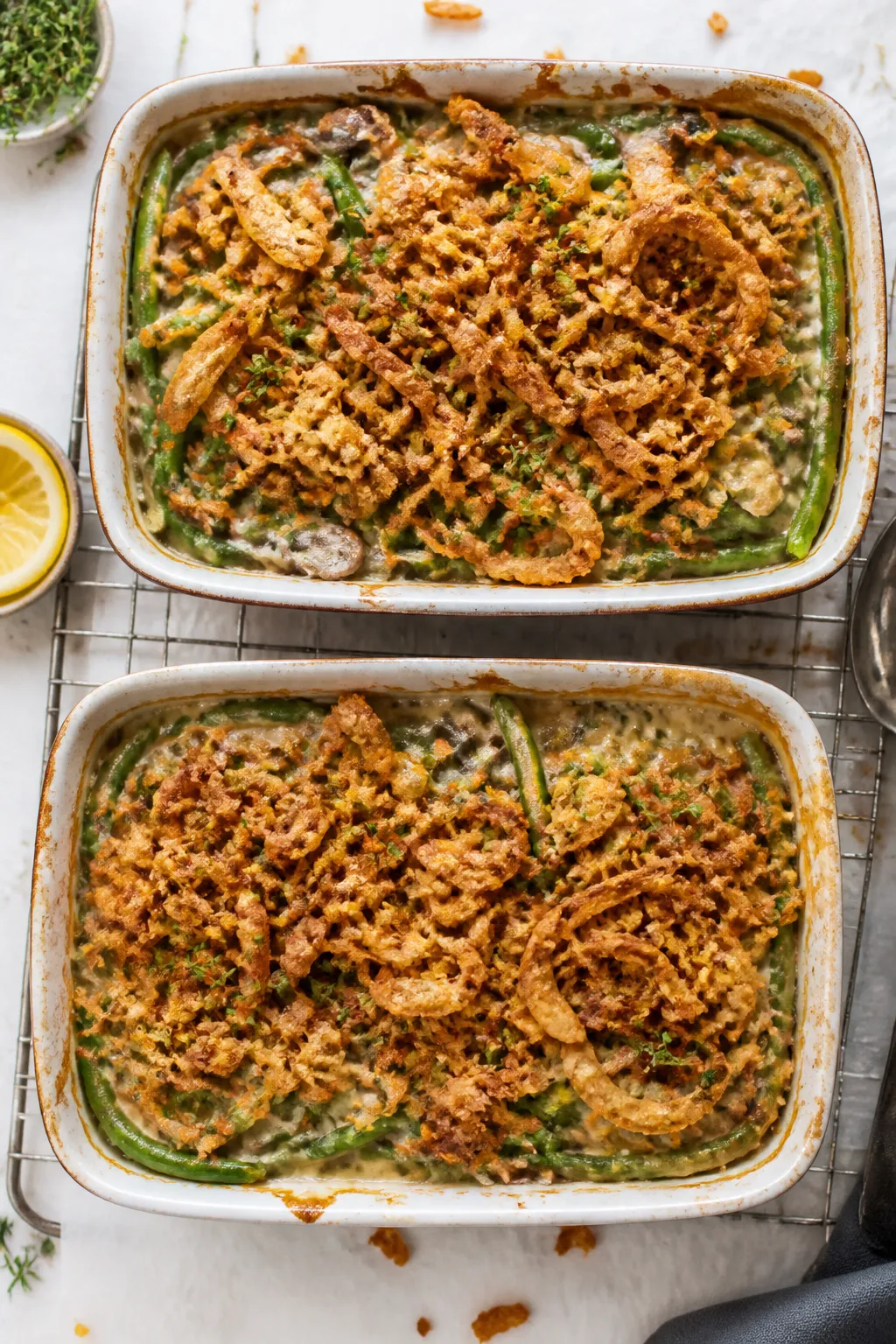 Final dish top-down: Overhead shot of two bubbling green bean casseroles in 9x13 pans fresh from the